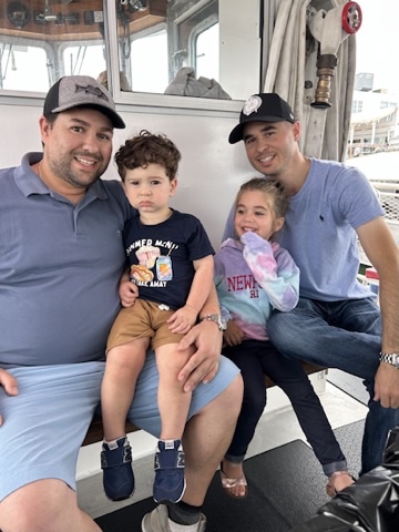 Mike DelRose Jr., his son Jack with Bobby McShane and his daughter Emma pose for a photo on a boat