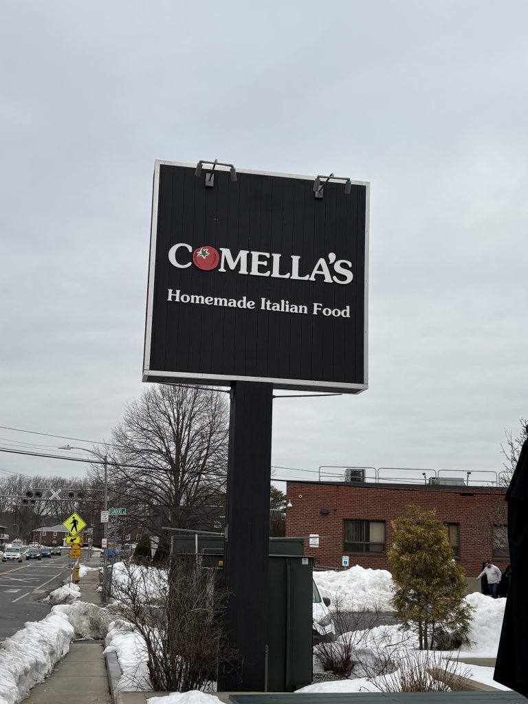 A photo of the sign for Comella's Homemade Italian Food located on Brighton Street In Belmont